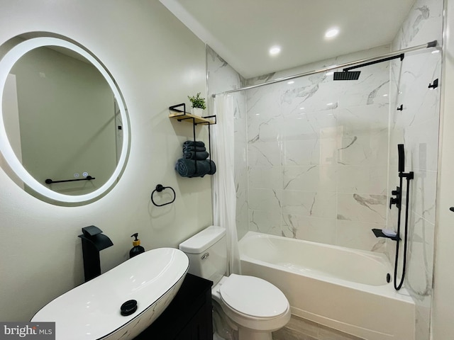 full bathroom with tiled shower / bath combo, vanity, hardwood / wood-style flooring, and toilet