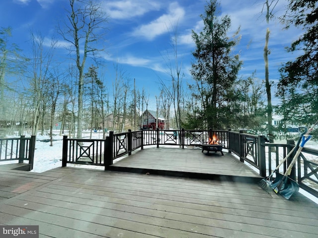 snow covered deck with a fire pit