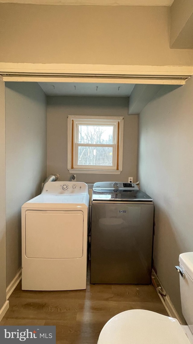 laundry area featuring hardwood / wood-style floors and washer and clothes dryer