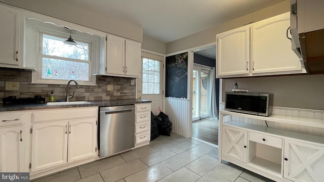 kitchen featuring white cabinetry, sink, decorative backsplash, and stainless steel appliances