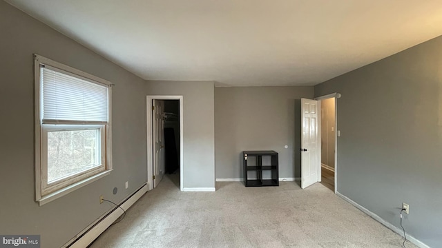 interior space with light carpet and a baseboard radiator