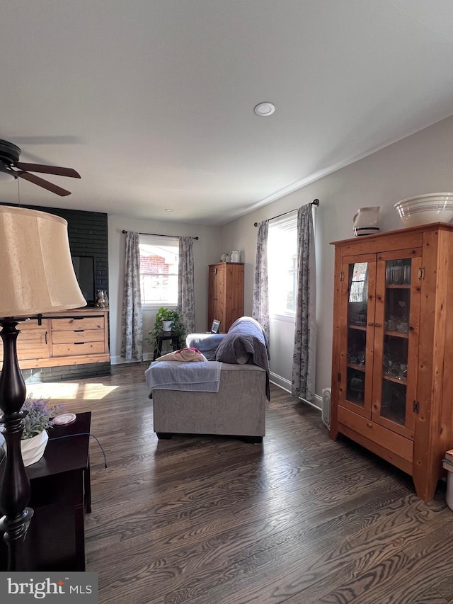 living room featuring dark hardwood / wood-style floors and ceiling fan