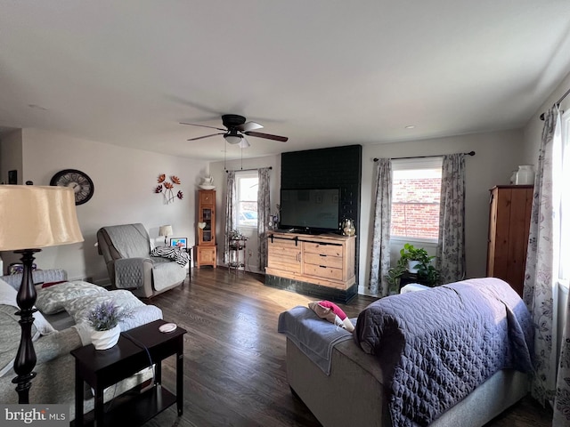 living room featuring ceiling fan and dark hardwood / wood-style flooring