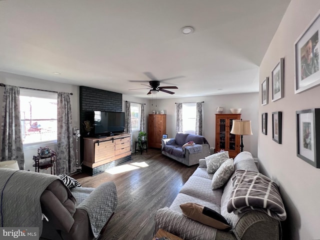 living room featuring dark hardwood / wood-style flooring and ceiling fan