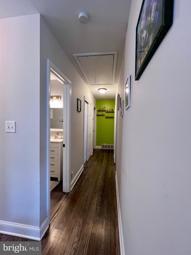 hallway with dark hardwood / wood-style flooring