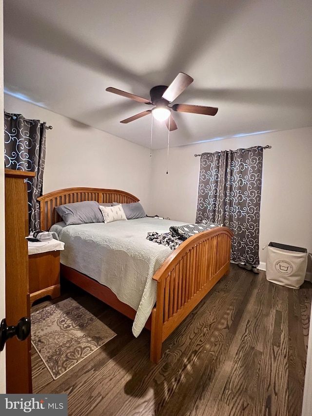 bedroom featuring dark hardwood / wood-style floors and ceiling fan