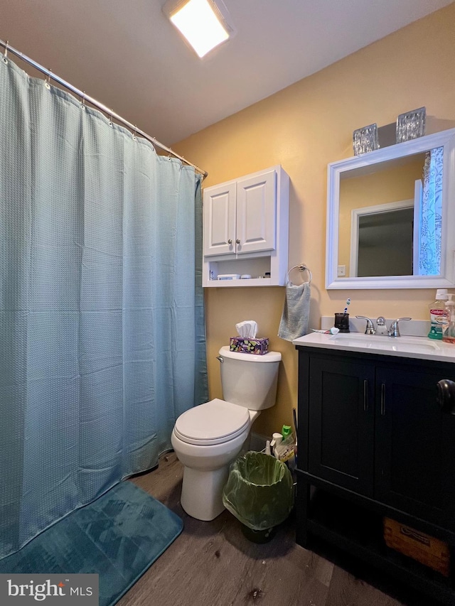 bathroom featuring hardwood / wood-style flooring, vanity, a shower with curtain, and toilet