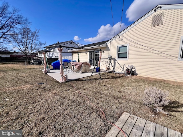 rear view of house featuring a gazebo and a patio area