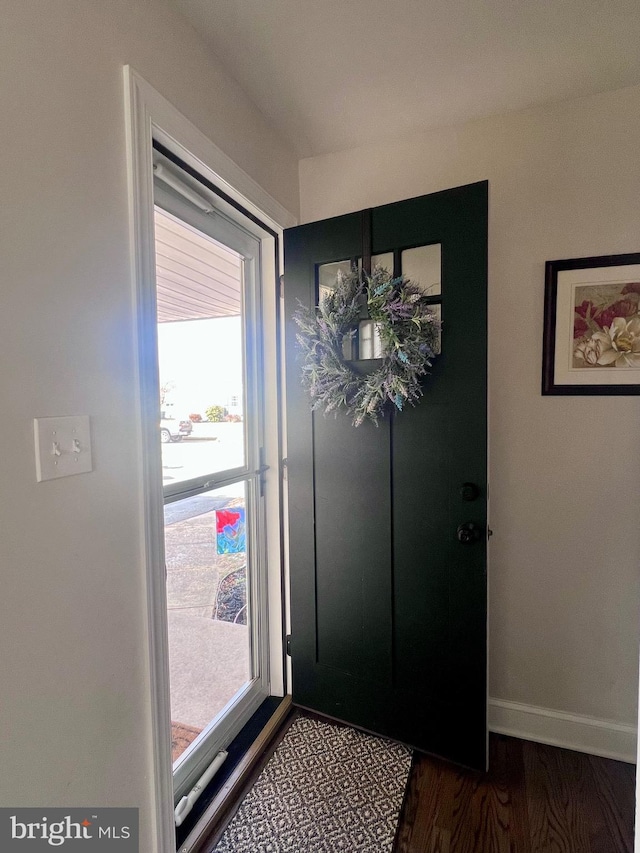 entryway with dark hardwood / wood-style flooring