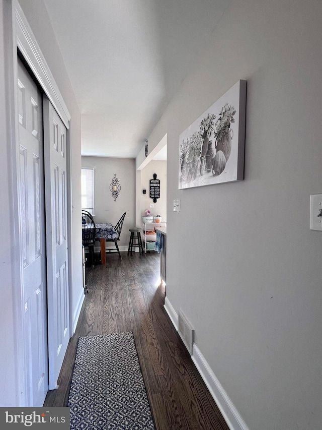 corridor featuring dark hardwood / wood-style floors