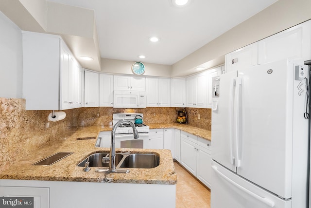 kitchen featuring sink, white cabinets, and white appliances