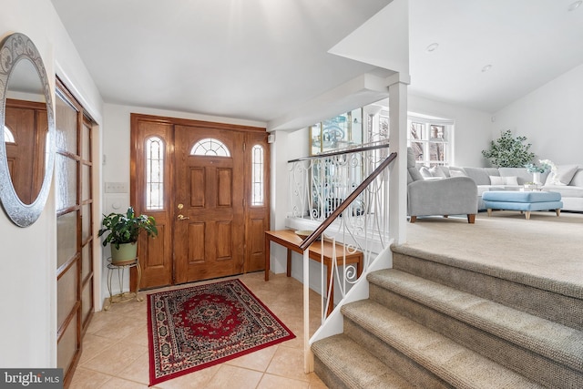 tiled foyer entrance featuring vaulted ceiling