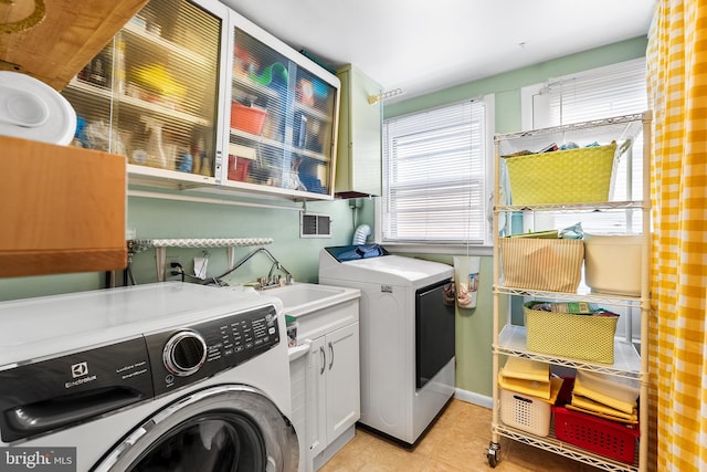 washroom with cabinets, light tile patterned flooring, sink, and independent washer and dryer