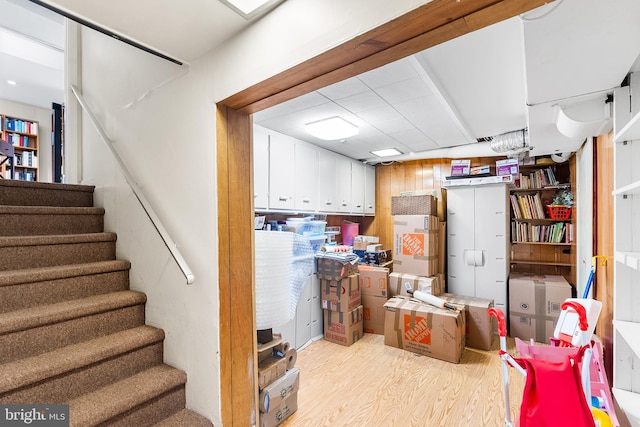 basement with light hardwood / wood-style floors