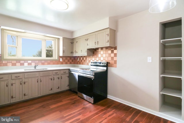 kitchen featuring stainless steel appliances, a sink, dark wood finished floors, backsplash, and light countertops