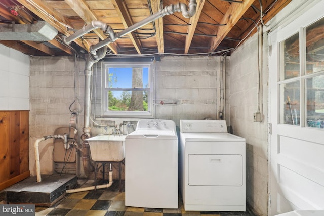 laundry room featuring washing machine and dryer, a sink, and laundry area
