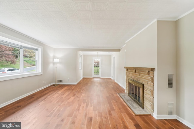 unfurnished living room with baseboards, light wood-style flooring, and visible vents