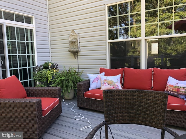 wooden terrace featuring outdoor lounge area