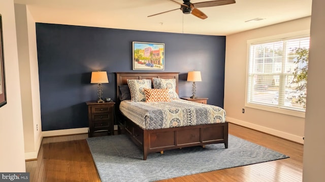 bedroom featuring hardwood / wood-style floors and ceiling fan