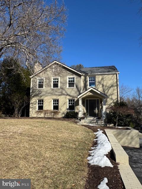 traditional-style home with a front lawn