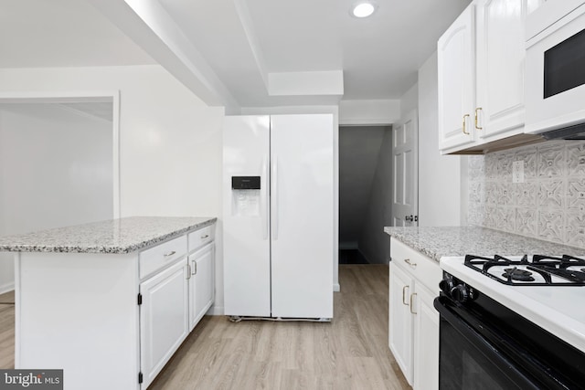 kitchen featuring light stone counters, light hardwood / wood-style flooring, white appliances, decorative backsplash, and white cabinets