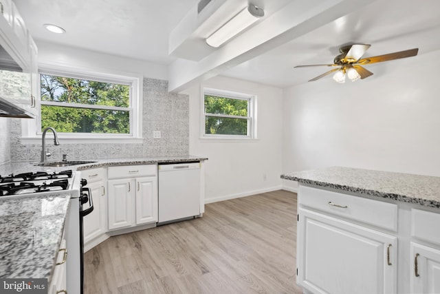 kitchen with white cabinetry, dishwasher, sink, and light stone counters