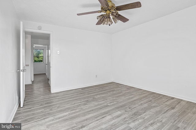 unfurnished room featuring ceiling fan and light hardwood / wood-style flooring