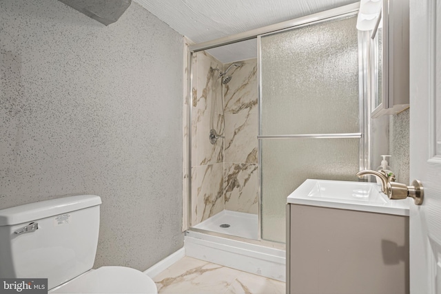 bathroom with vanity, toilet, and a shower with shower door