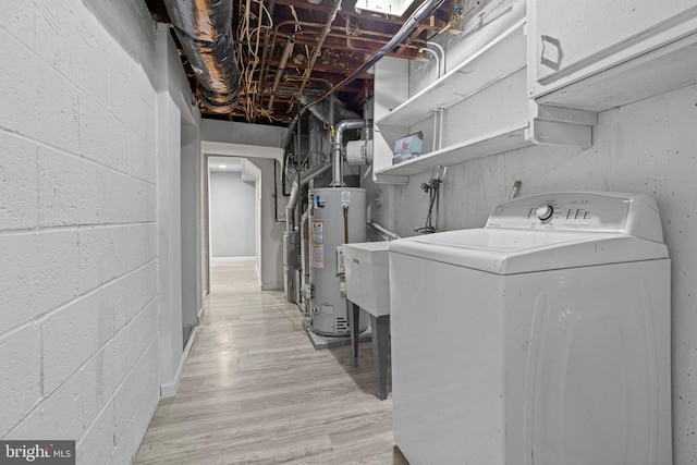 laundry room featuring gas water heater, washer / dryer, and light hardwood / wood-style floors