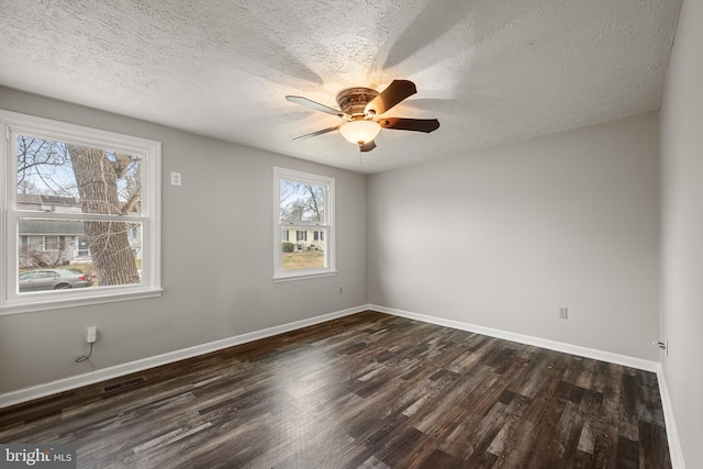 spare room featuring dark hardwood / wood-style flooring, a textured ceiling, and ceiling fan