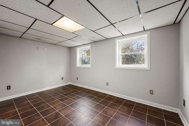 basement with a paneled ceiling