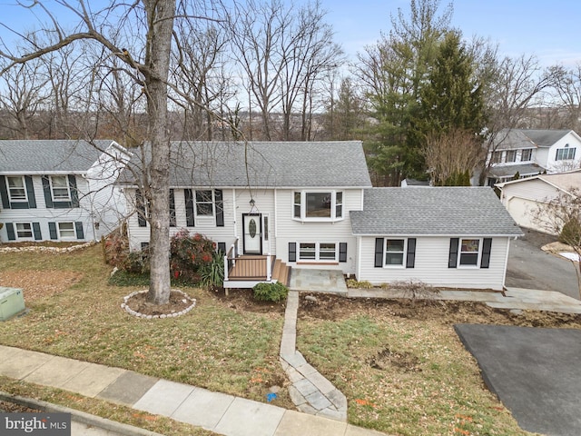 raised ranch with a front yard