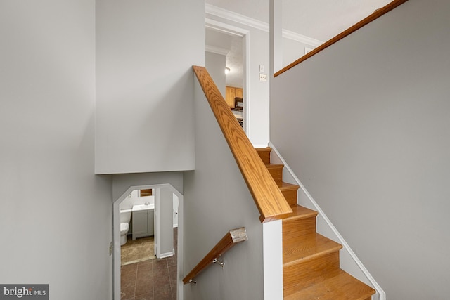 stairway featuring ornamental molding