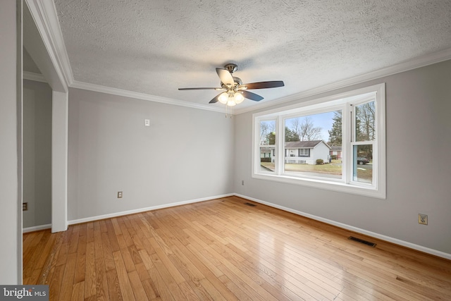 spare room featuring ornamental molding, a textured ceiling, ceiling fan, and light hardwood / wood-style flooring