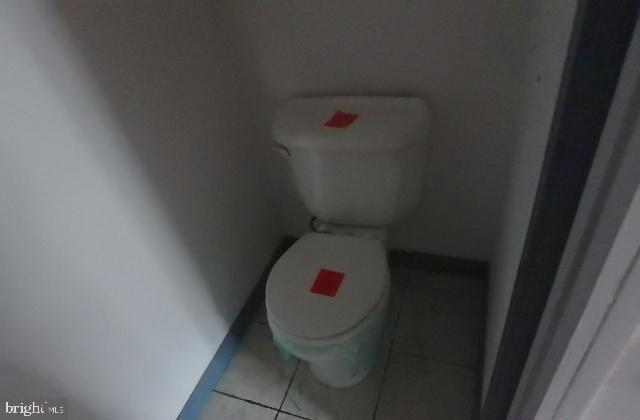 bathroom with tile patterned floors and toilet