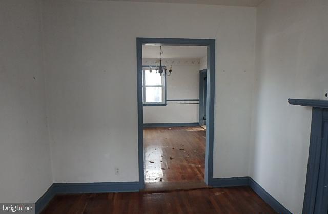 empty room with dark hardwood / wood-style flooring