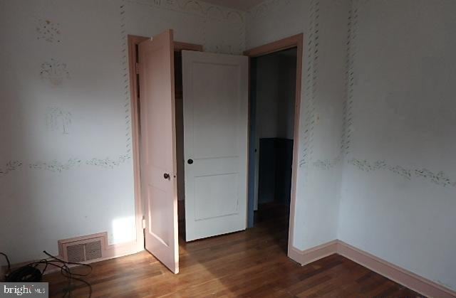 empty room with wood-type flooring