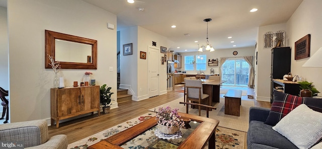 living room with a notable chandelier and wood-type flooring