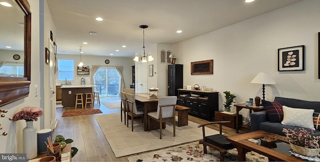 dining room with a notable chandelier and light hardwood / wood-style flooring