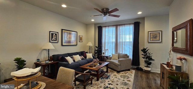 living room featuring dark wood-type flooring and ceiling fan