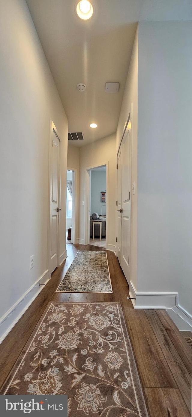 corridor featuring dark hardwood / wood-style flooring