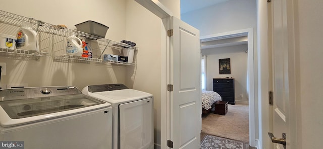 laundry room with washing machine and dryer and carpet