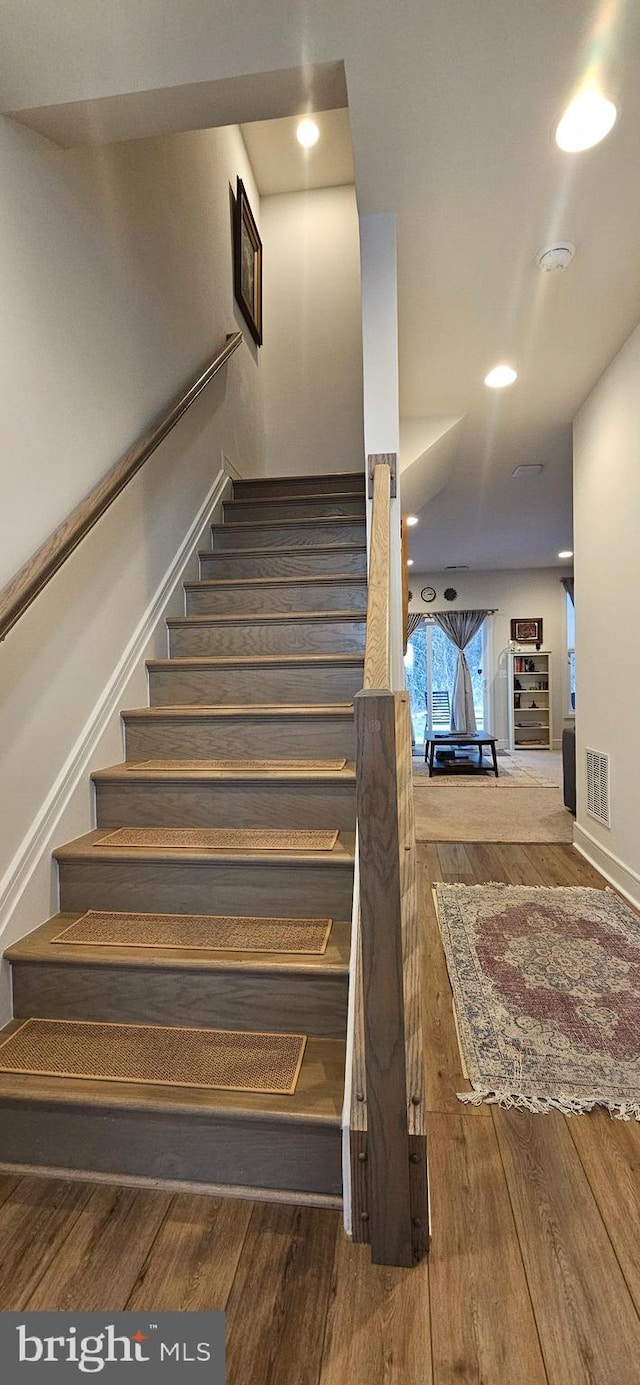 staircase featuring hardwood / wood-style floors