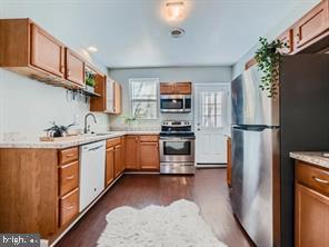 kitchen with sink, dark wood-type flooring, and appliances with stainless steel finishes