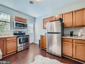 kitchen with stainless steel appliances and dark hardwood / wood-style flooring