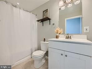 full bathroom with shower / bath combination with curtain, vanity, and toilet