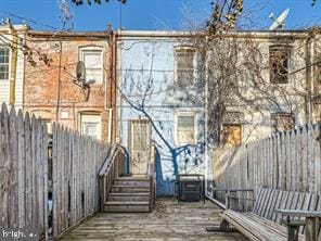 back of house with a wooden deck and central AC unit