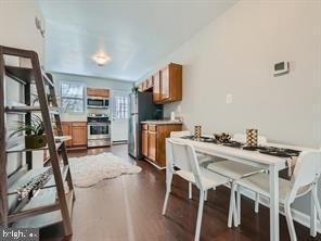 kitchen with dark hardwood / wood-style flooring and stainless steel appliances