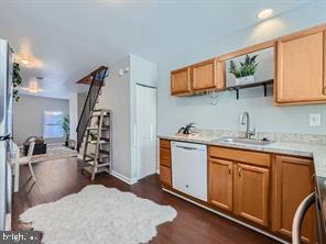 kitchen featuring white dishwasher, sink, dark hardwood / wood-style floors, and range