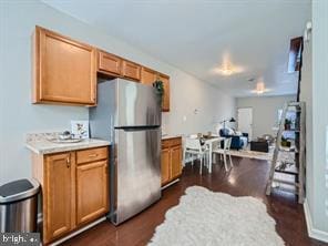 kitchen with stainless steel refrigerator and dark hardwood / wood-style floors